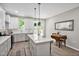 Bright kitchen boasts a spacious island, stainless appliances, a dining nook, and access to outdoor deck at 1824 Irish Blvd, Sanford, NC 27332