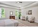 Large main bedroom featuring a tray ceiling, a ceiling fan, and two windows offering plenty of natural light at 1824 Irish Blvd, Sanford, NC 27332