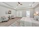 Spacious main bedroom featuring a tray ceiling, ensuite bathroom, and a seating area with ample natural light at 1824 Irish Blvd, Sanford, NC 27332