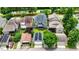 Aerial view of houses with solar panels on the roofs, lush trees and green lawns, and a red car at 1962 Briar Chapel Pkwy, Chapel Hill, NC 27516