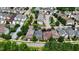 Aerial view of a neighborhood with lots of mature trees, green lawns, and solar panels on some of the houses at 1962 Briar Chapel Pkwy, Chapel Hill, NC 27516