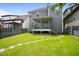 Backyard features a well-maintained lawn, stone path, screened porch, and established landscaping for relaxation and enjoyment at 1962 Briar Chapel Pkwy, Chapel Hill, NC 27516