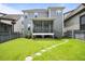 Beautiful backyard showcasing lush green lawn, a screened-in porch, and a stone pathway, perfect for outdoor living at 1962 Briar Chapel Pkwy, Chapel Hill, NC 27516