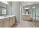 This large bathroom features dual vanities, a soaking tub and glass shower at 1962 Briar Chapel Pkwy, Chapel Hill, NC 27516
