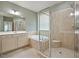Bright bathroom featuring a tiled shower, soaking tub, and neutral-toned vanity for a soothing and modern experience at 1962 Briar Chapel Pkwy, Chapel Hill, NC 27516