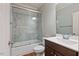 Bathroom featuring a shower over tub combination with glass doors and wood vanity at 1962 Briar Chapel Pkwy, Chapel Hill, NC 27516