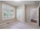 Neutral bedroom featuring a large window with shutters and closet with paneled doors at 1962 Briar Chapel Pkwy, Chapel Hill, NC 27516