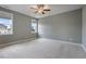 Spacious bedroom featuring two windows, plush carpet, neutral walls and white trim at 1962 Briar Chapel Pkwy, Chapel Hill, NC 27516