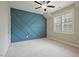 Bedroom with custom blue accent wall, carpet, and ample natural light at 1962 Briar Chapel Pkwy, Chapel Hill, NC 27516