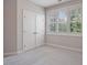 Bright bedroom with large windows, white trim, plush carpet, and a storage closet at 1962 Briar Chapel Pkwy, Chapel Hill, NC 27516