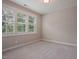 Neutral bedroom with carpet and large window with shutter style blinds at 1962 Briar Chapel Pkwy, Chapel Hill, NC 27516