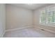 Neutral bedroom featuring plush carpet, a window, and white trim at 1962 Briar Chapel Pkwy, Chapel Hill, NC 27516