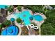 Aerial view of a large community pool, green umbrellas, lots of seating and a water slide at 1962 Briar Chapel Pkwy, Chapel Hill, NC 27516