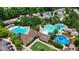 Aerial view of a large community pool area with a water slide, playground and splash pad at 1962 Briar Chapel Pkwy, Chapel Hill, NC 27516