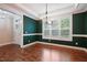 Dining room with hardwood floors, decorative trim, large windows, and modern chandelier at 1962 Briar Chapel Pkwy, Chapel Hill, NC 27516