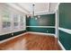 Dining room with hardwood floors, decorative trim, large windows, and modern chandelier at 1962 Briar Chapel Pkwy, Chapel Hill, NC 27516