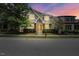 Charming two-story home features a manicured lawn, brick accents, and a welcoming yellow front door at 1962 Briar Chapel Pkwy, Chapel Hill, NC 27516