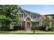 Charming two-story home features a manicured lawn, brick accents, and a welcoming yellow front door at 1962 Briar Chapel Pkwy, Chapel Hill, NC 27516