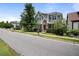 Charming two-story home features a manicured lawn, brick accents, and a welcoming yellow front door at 1962 Briar Chapel Pkwy, Chapel Hill, NC 27516