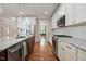 Kitchen with stainless appliances, white cabinetry, granite countertops, and a kitchen island at 1962 Briar Chapel Pkwy, Chapel Hill, NC 27516