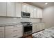 Modern kitchen design with stainless steel oven, microwave, and granite countertops at 1962 Briar Chapel Pkwy, Chapel Hill, NC 27516