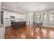 Spacious kitchen featuring wood floors, white cabinets, an island, and stainless steel appliances at 1962 Briar Chapel Pkwy, Chapel Hill, NC 27516
