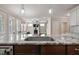 Kitchen island with granite countertop, stainless steel sink, and view of the living room at 1962 Briar Chapel Pkwy, Chapel Hill, NC 27516