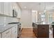 Kitchen featuring white cabinets, granite countertops, stainless appliances, and a kitchen island at 1962 Briar Chapel Pkwy, Chapel Hill, NC 27516