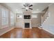 Bright living room with hardwood floors, fireplace, and staircase to the upper level at 1962 Briar Chapel Pkwy, Chapel Hill, NC 27516