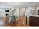 Open-concept living room with hardwood floors, fireplace, and modern kitchen area at 1962 Briar Chapel Pkwy, Chapel Hill, NC 27516