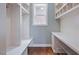 Functional mudroom with custom white shelving, seating, and storage cabinets at 1962 Briar Chapel Pkwy, Chapel Hill, NC 27516