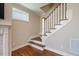 Staircase with hardwood steps and white railing leading to the upper level at 1962 Briar Chapel Pkwy, Chapel Hill, NC 27516