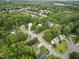 Aerial view of a neighborhood with mature trees and manicured lawns at 200 Holly Branch Dr, Holly Springs, NC 27540