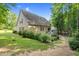 Well-maintained backyard with mature trees, deck and landscaped grounds at 200 Holly Branch Dr, Holly Springs, NC 27540