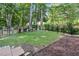 Well-manicured backyard with a lush lawn and black metal fencing at 200 Holly Branch Dr, Holly Springs, NC 27540