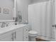 Bright bathroom featuring a white vanity, framed mirror, and shower with white curtain at 200 Holly Branch Dr, Holly Springs, NC 27540