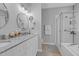 Updated bathroom features a granite countertop, a walk-in shower, and a separate bathtub at 200 Holly Branch Dr, Holly Springs, NC 27540