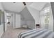 Bright bedroom featuring carpet flooring, a ceiling fan, sloped ceilings, a bedside table and an arched window at 200 Holly Branch Dr, Holly Springs, NC 27540