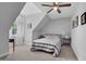 Charming bedroom with carpet flooring, sloped ceilings, a ceiling fan, and a comfortable bed with bedside tables at 200 Holly Branch Dr, Holly Springs, NC 27540