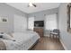 Cozy bedroom featuring a ceiling fan and light, airy decor, with light-colored wood flooring at 200 Holly Branch Dr, Holly Springs, NC 27540