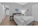 Brightly lit bedroom featuring light-colored wood flooring and a cozy bed area at 200 Holly Branch Dr, Holly Springs, NC 27540