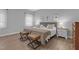 This bedroom features two beds, two bedside tables, and two ottomans for seating at 200 Holly Branch Dr, Holly Springs, NC 27540