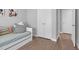 Brightly lit bedroom featuring ample closet space with double doors and light-colored wood flooring at 200 Holly Branch Dr, Holly Springs, NC 27540