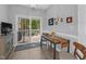 Sunny breakfast nook with table and chairs, leading to outdoor deck at 200 Holly Branch Dr, Holly Springs, NC 27540
