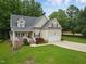 Charming two-story traditional home with a well-maintained lawn and attached two-car garage at 200 Holly Branch Dr, Holly Springs, NC 27540