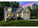 Charming two-story traditional home with a well-maintained lawn and attached two-car garage at 200 Holly Branch Dr, Holly Springs, NC 27540