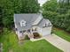 Aerial view of a charming two-story traditional home with well maintained lawn at 200 Holly Branch Dr, Holly Springs, NC 27540