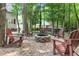 Cozy backyard fire pit surrounded by Adirondack chairs on a stone area at 200 Holly Branch Dr, Holly Springs, NC 27540