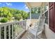 Inviting front porch featuring white rocking chairs and an American flag, perfect for relaxing and enjoying the outdoors at 200 Holly Branch Dr, Holly Springs, NC 27540