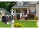 Charming front yard view featuring a mailbox with house number and a well-maintained lawn at 200 Holly Branch Dr, Holly Springs, NC 27540